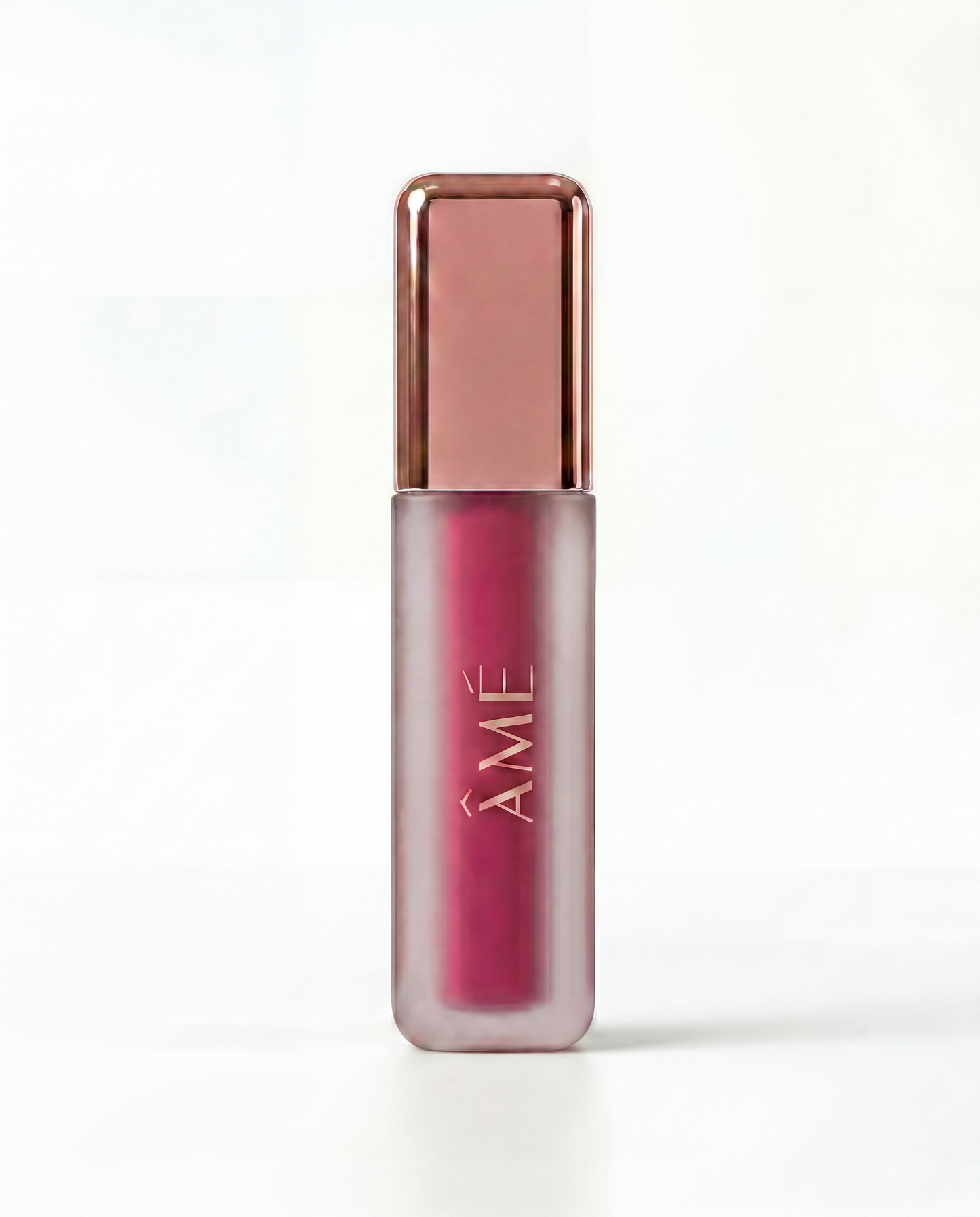 blush tint with rose gold cap on a white background